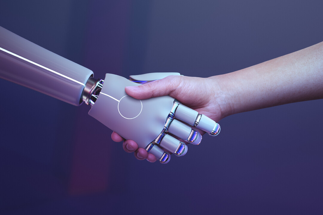 robot hand holding hands with a human hand